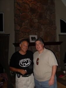 Two men at an event in matching shirts